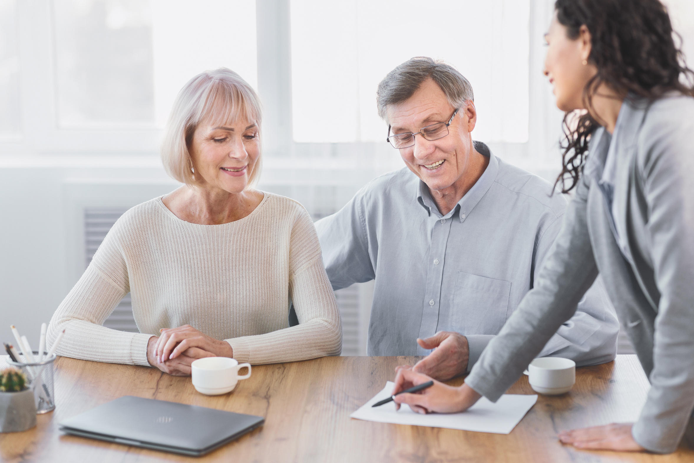Older couple meeting with a tax professional at a table