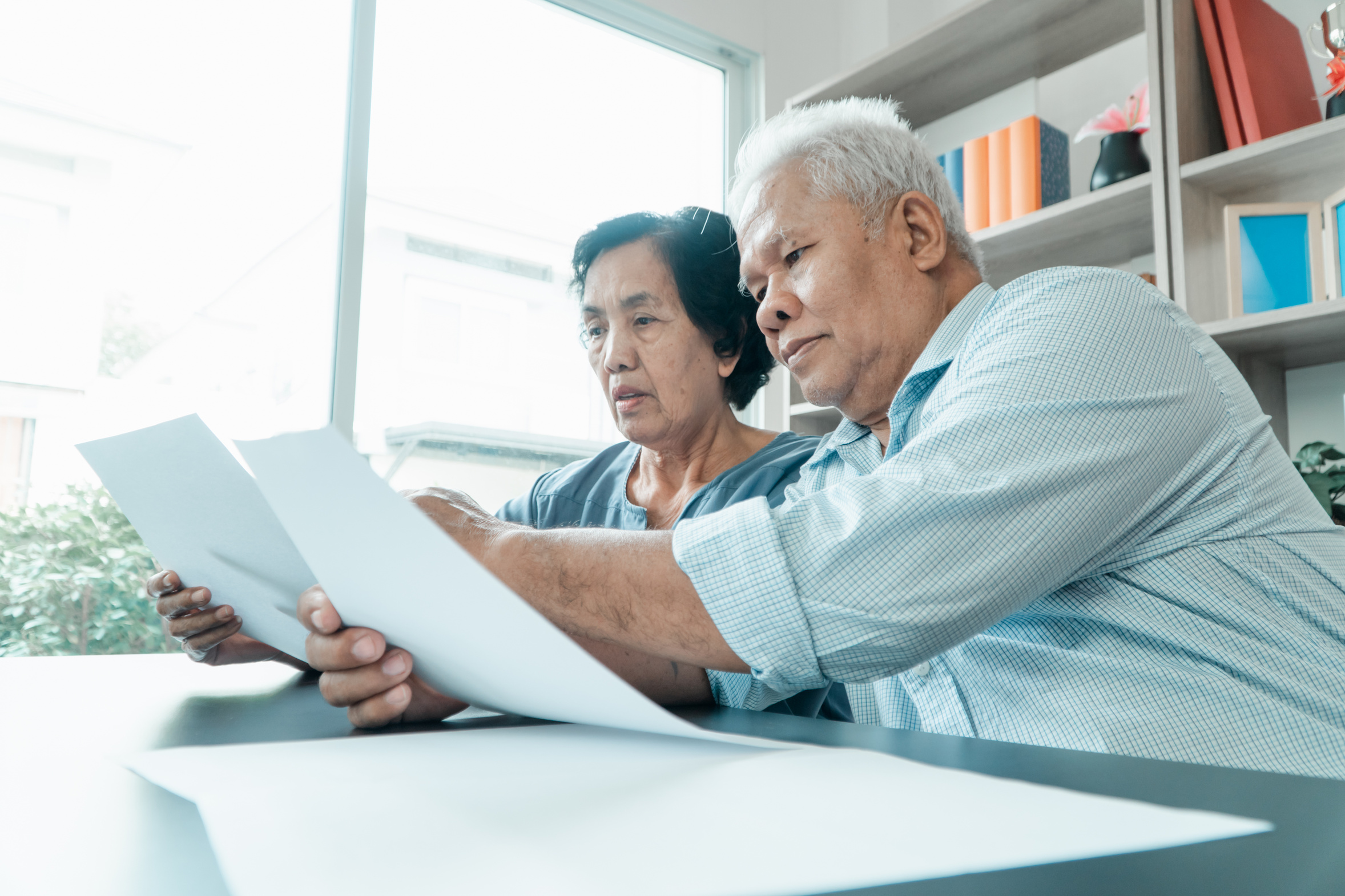 Older couple reviewing account statements together